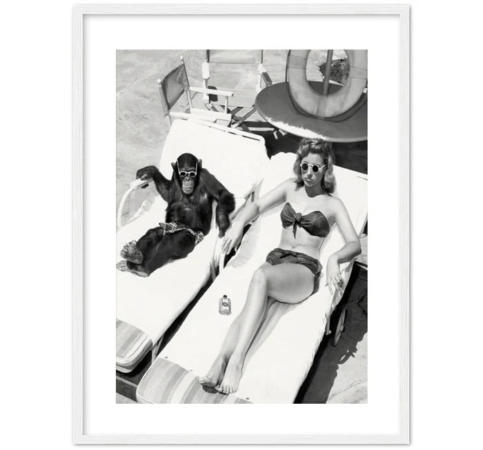 WOMEN SUNBATHING WITH CHIMPANZEE